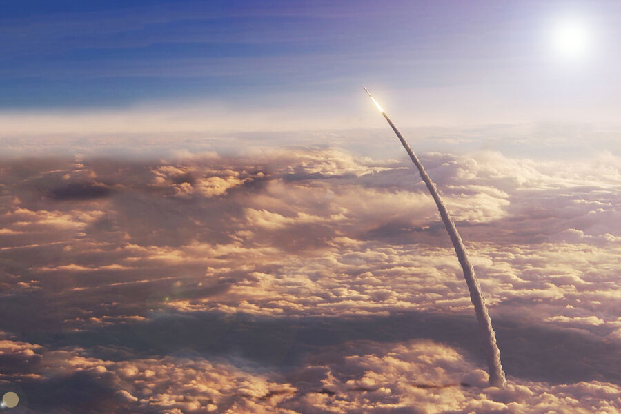rocket taking off towards space in Earth's upper atmosphere